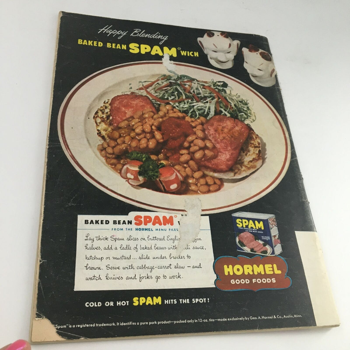 Back cover of a vintage recipe pamphlet featuring a baked bean Spamwich advertisement, showcasing a dish with spam and baked beans, along with promotional images of Hormel Spam products.