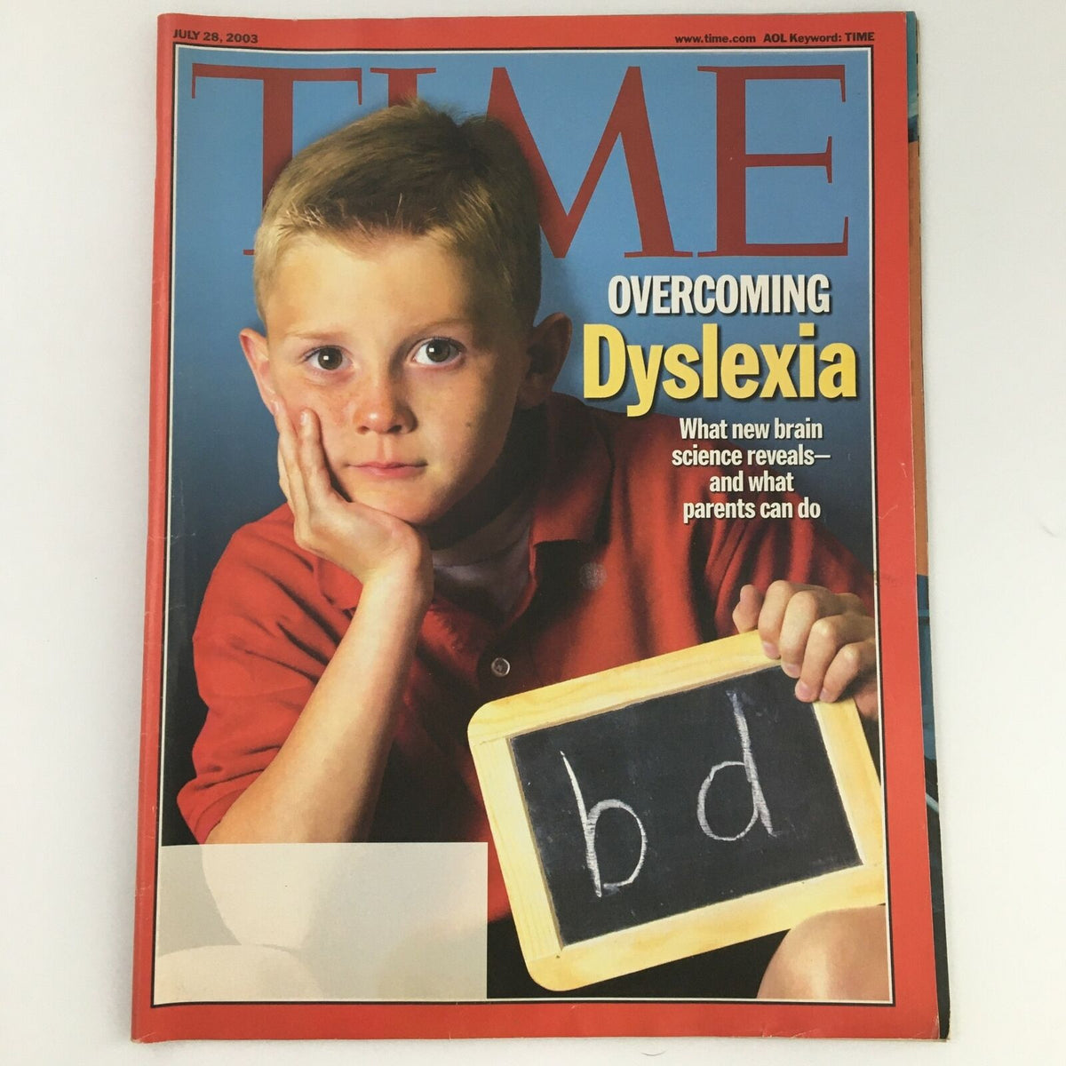 Cover of Time Magazine dated July 28, 2003, featuring an article on 'Overcoming Dyslexia' with a young boy holding a chalkboard displaying the letters 'b' and 'd'.