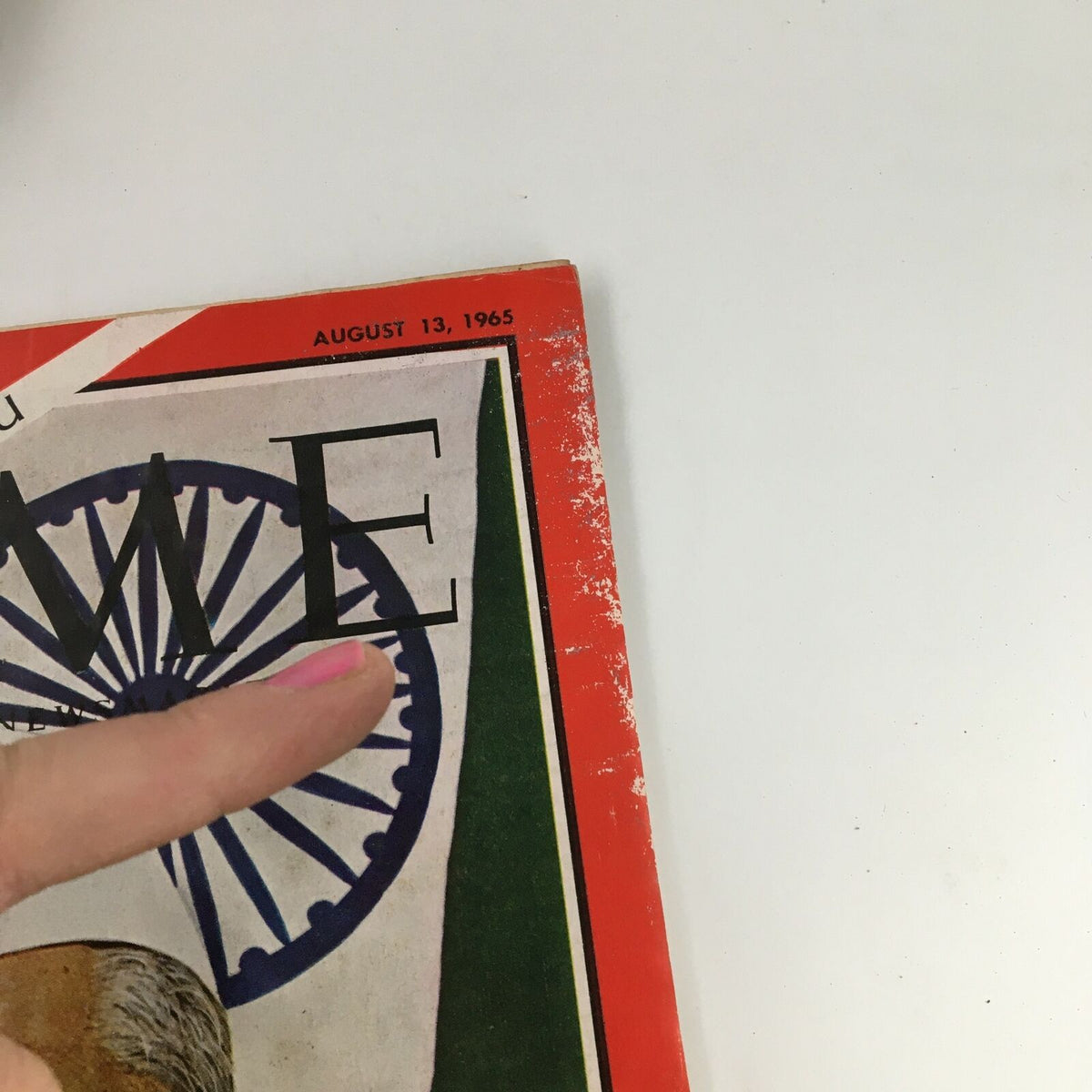 Top corner view of Time Magazine from August 13, 1965, Vol 86 #7, showing the date and part of the cover design with India's national emblem.