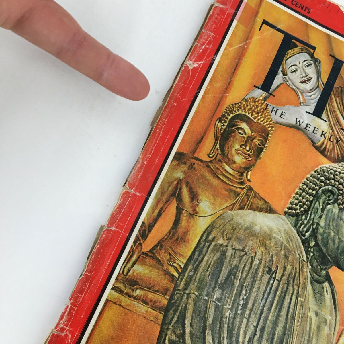 Close-up of Time Magazine December 11 1964 showing the edge of the cover with details on Buddha statues.