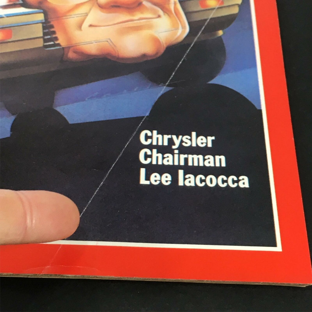 Close-up of the cover of VTG Time Magazine March 21 1983, showcasing Chrysler Chairman Lee Iacocca's name prominently along with an artistic representation of a car. Ideal for collectors of vintage automotive memorabilia.