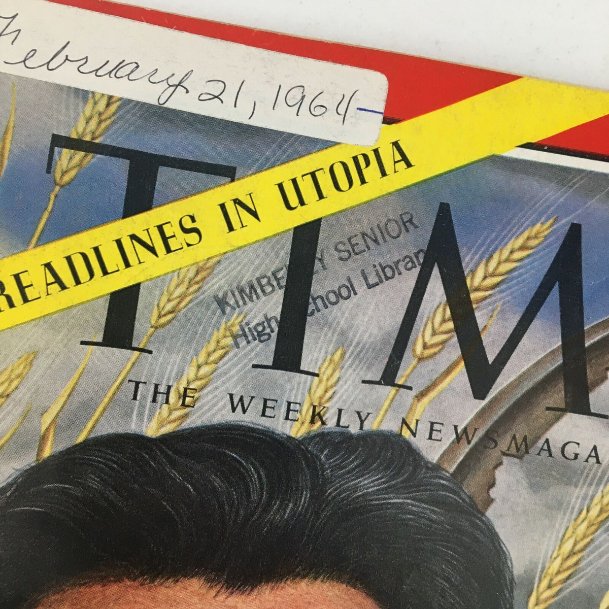 Detailed view of the Time Magazine February 21, 1964 cover showing the title and date, along with the library stamp on the magazine.