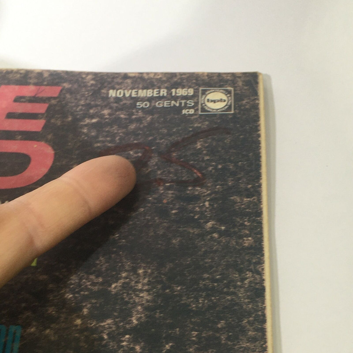 Close-up of the top corner of VTG Cycle World Magazine November 1969, highlighting the date, price, and signature on the cover.