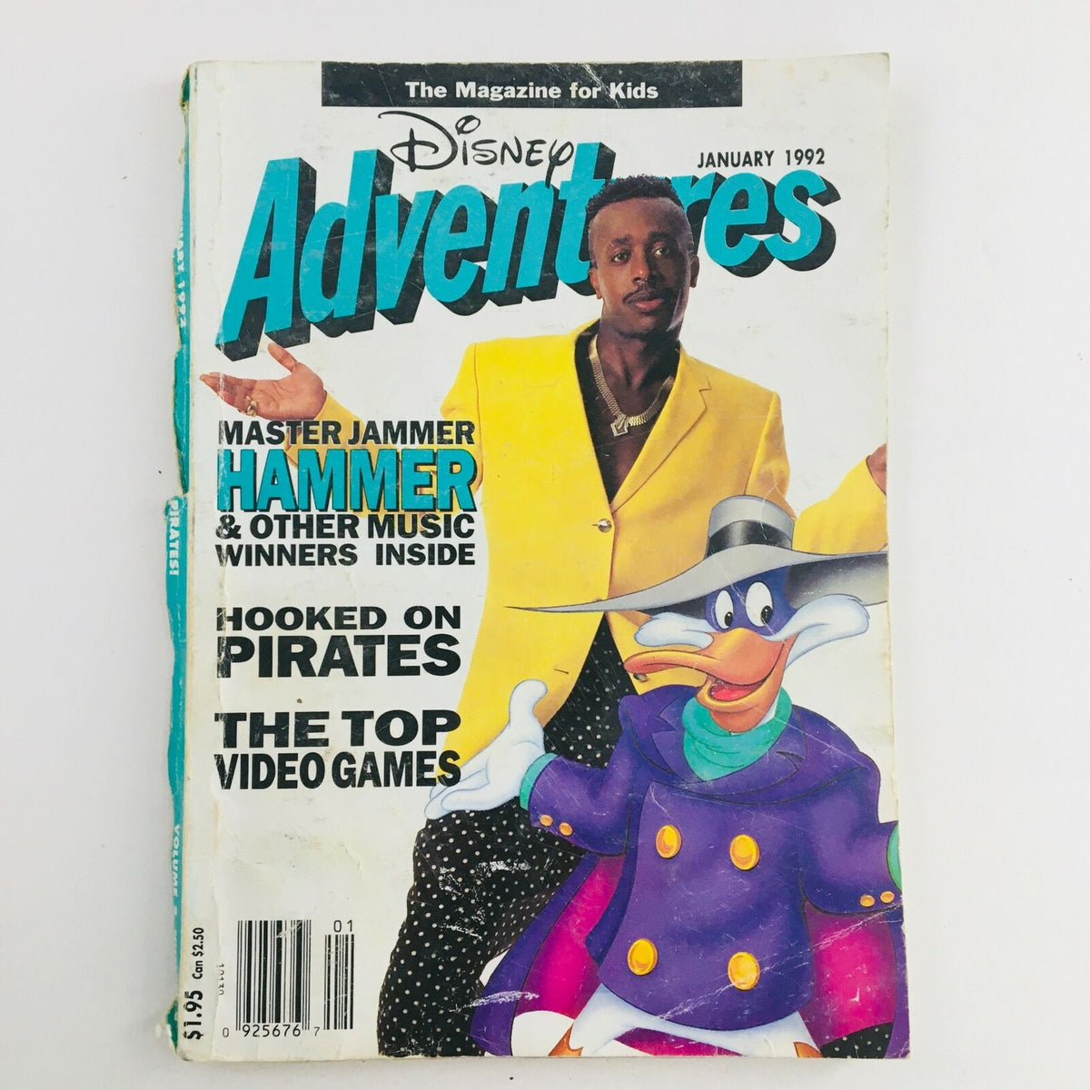 Cover of Disney Adventures Magazine January 1992 featuring Master Jammer MC Hammer in a vibrant yellow jacket next to a cartoon character, showcasing nostalgia and pop culture.