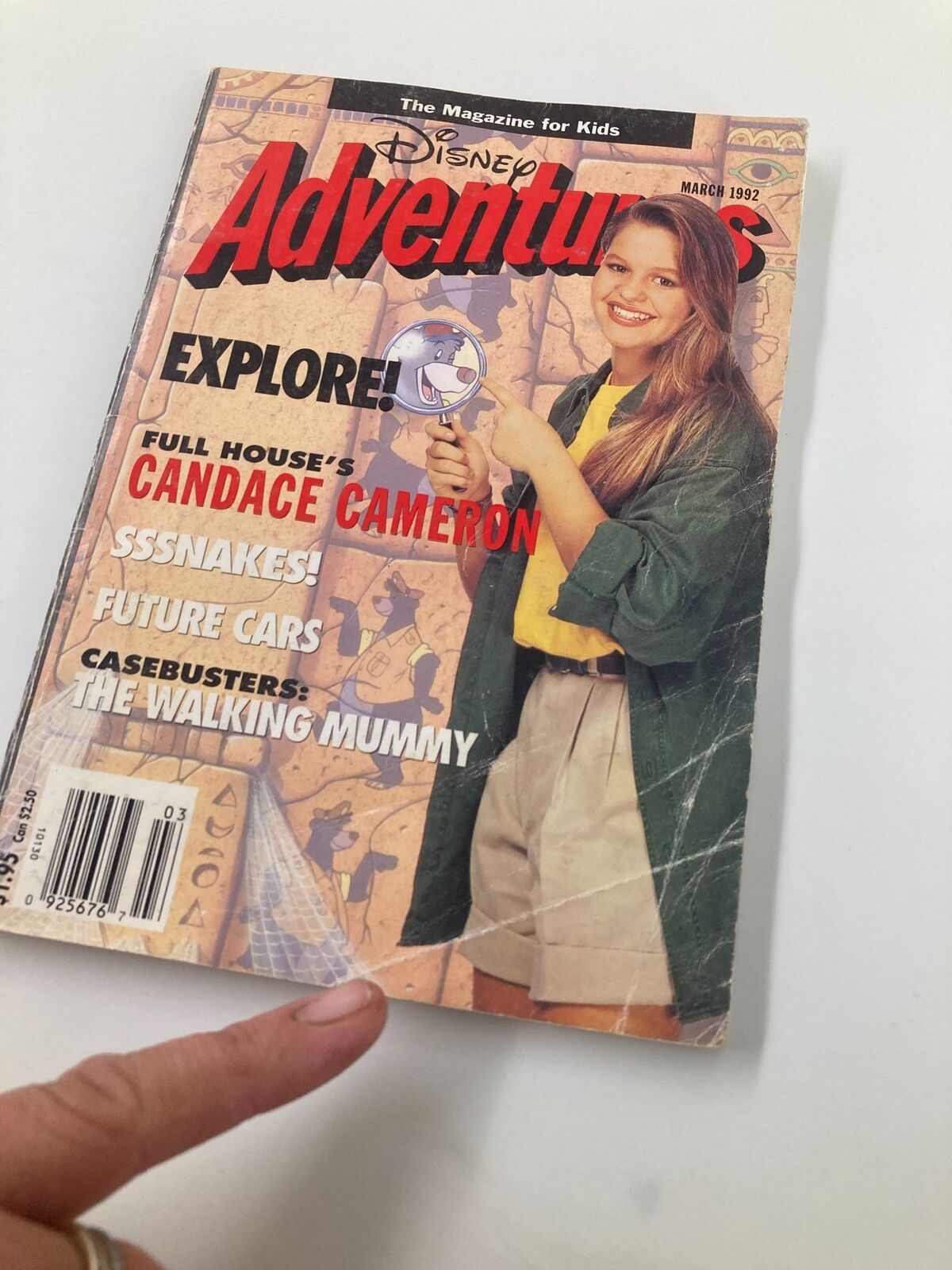 Close-up of the cover of Disney Adventures Magazine March 1992, highlighting Full House's Candace Cameron, with a finger pointing at the magazine's features.
