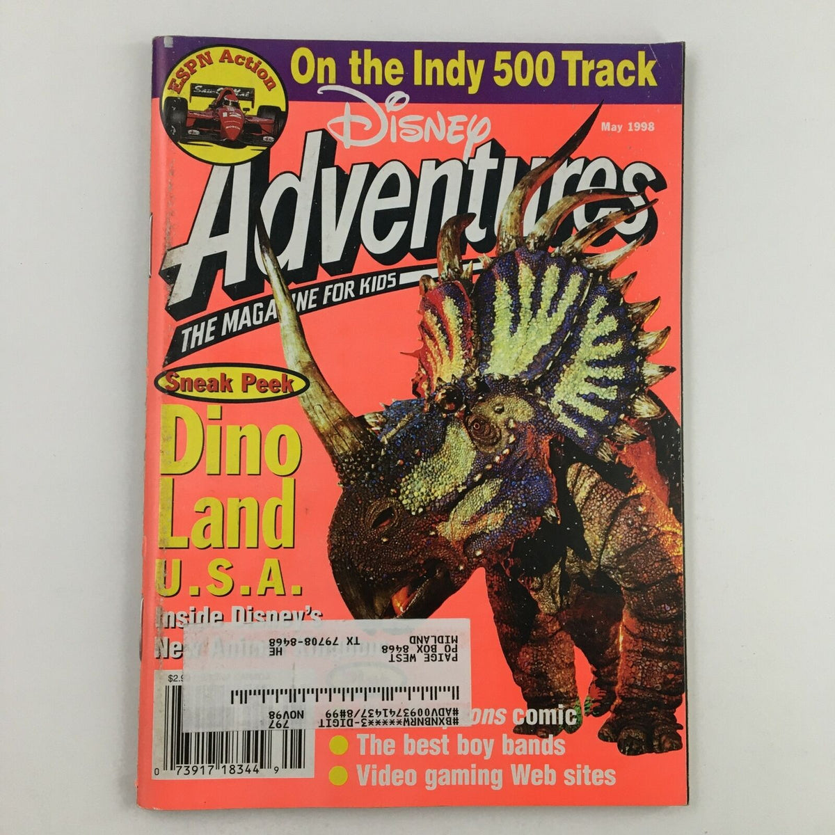 Cover of Disney Adventures Magazine May 1998 featuring a colorful dinosaur illustration and the headline 'Sneak Peek Dino Land U.S.A.' showcasing Disney's new attractions.