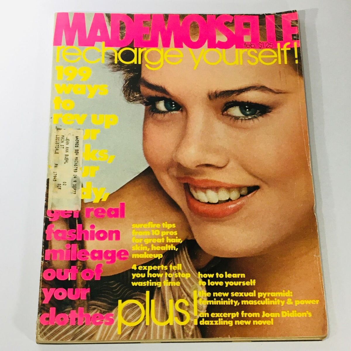 Cover of VTG Mademoiselle Magazine February 1977 featuring the headline 'Recharge Yourself!' and a smiling model with bright blue eyes, showcasing vintage fashion and beauty trends from the 1970s.