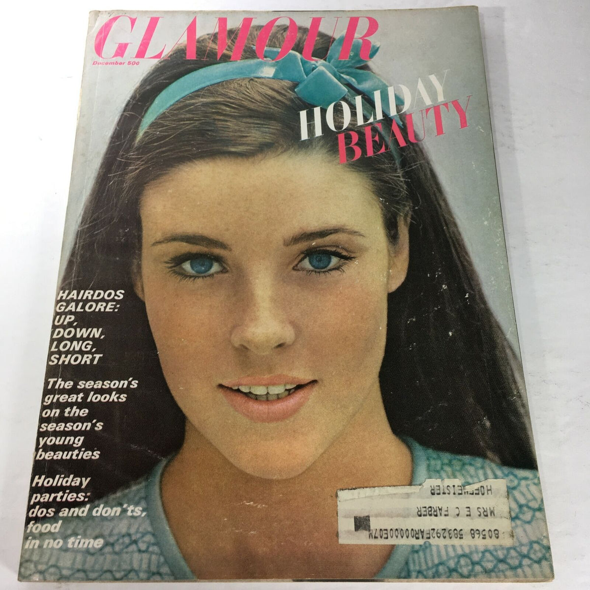 Cover of VTG Glamour Magazine: December 1965 - Holiday Beauty Issue featuring model Lisa Palmer, showcasing holiday hairstyles and beauty trends from the sixties.