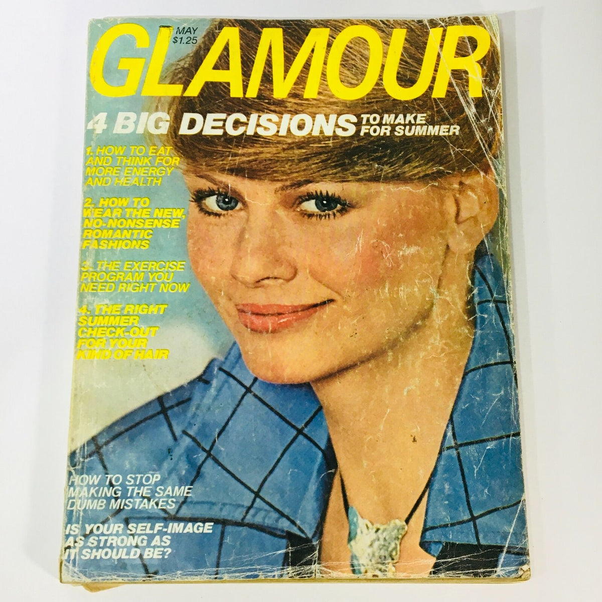 VTG Glamour Magazine May 1977 cover featuring a stylish woman with a chic hairstyle and blue attire, highlighting '4 Big Decisions To Make For Summer' with captivating fashion advice and nostalgic content.