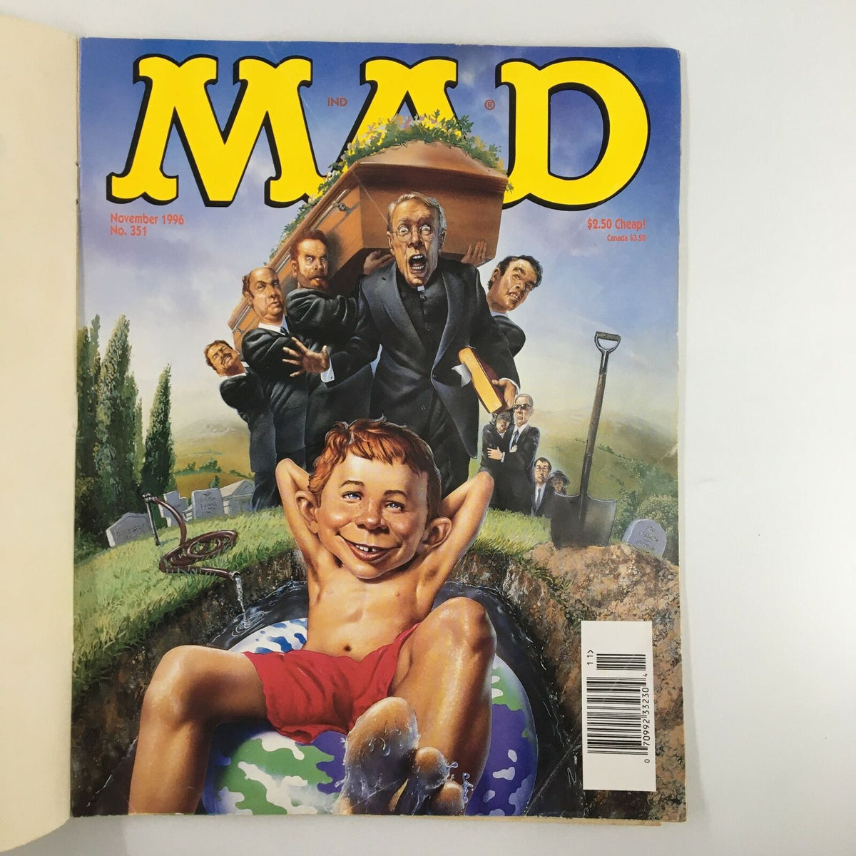 Cover of Mad Magazine November 1996 No. 351 featuring a humorous illustration of a boy lounging in a pool near a funeral scene, with mourners in black suits and a coffin, embodying the magazine's unique satire and cultural commentary.