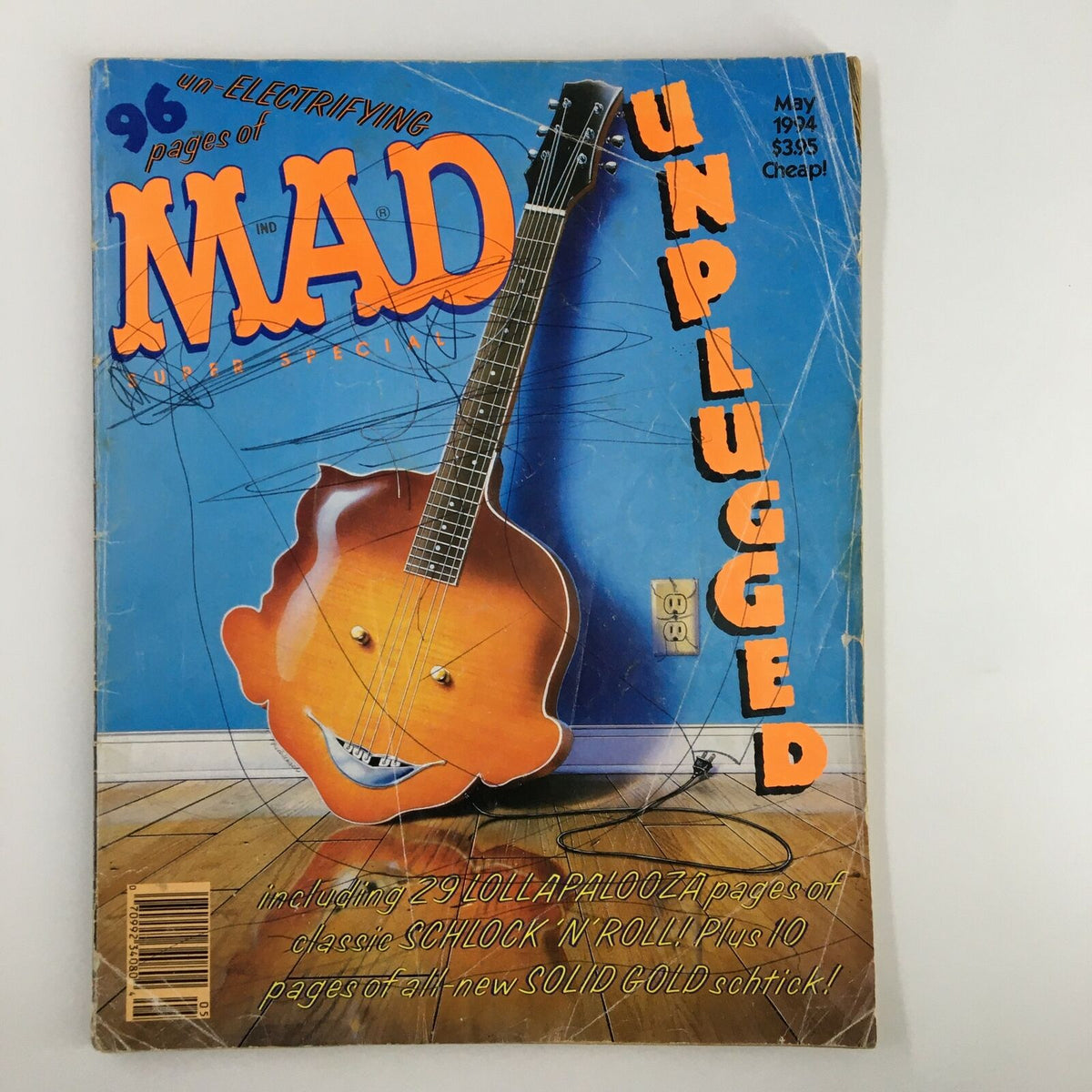 Cover of Mad Magazine May 1994 Unplugged 29 Lollapalooza featuring a cartoon guitar with a playful face, showcasing the vintage style and humor of the publication.