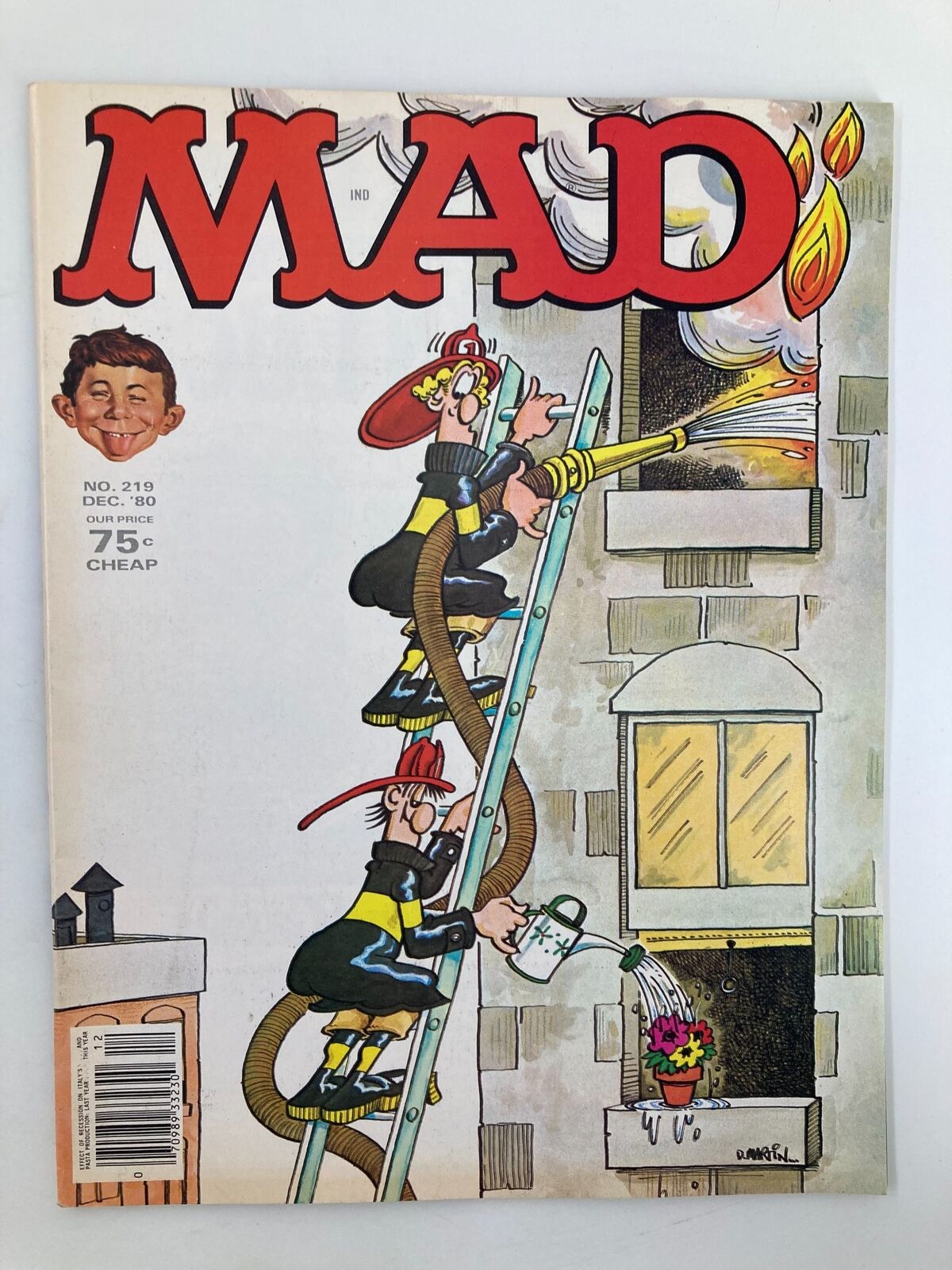 Mad Magazine December 1980 No. 219 cover featuring Don Martin's artwork, depicting humorous fireman characters using a watering can and hose while fighting a fire. This vintage magazine captures the iconic style and humor of the era, perfect for fans and collectors.