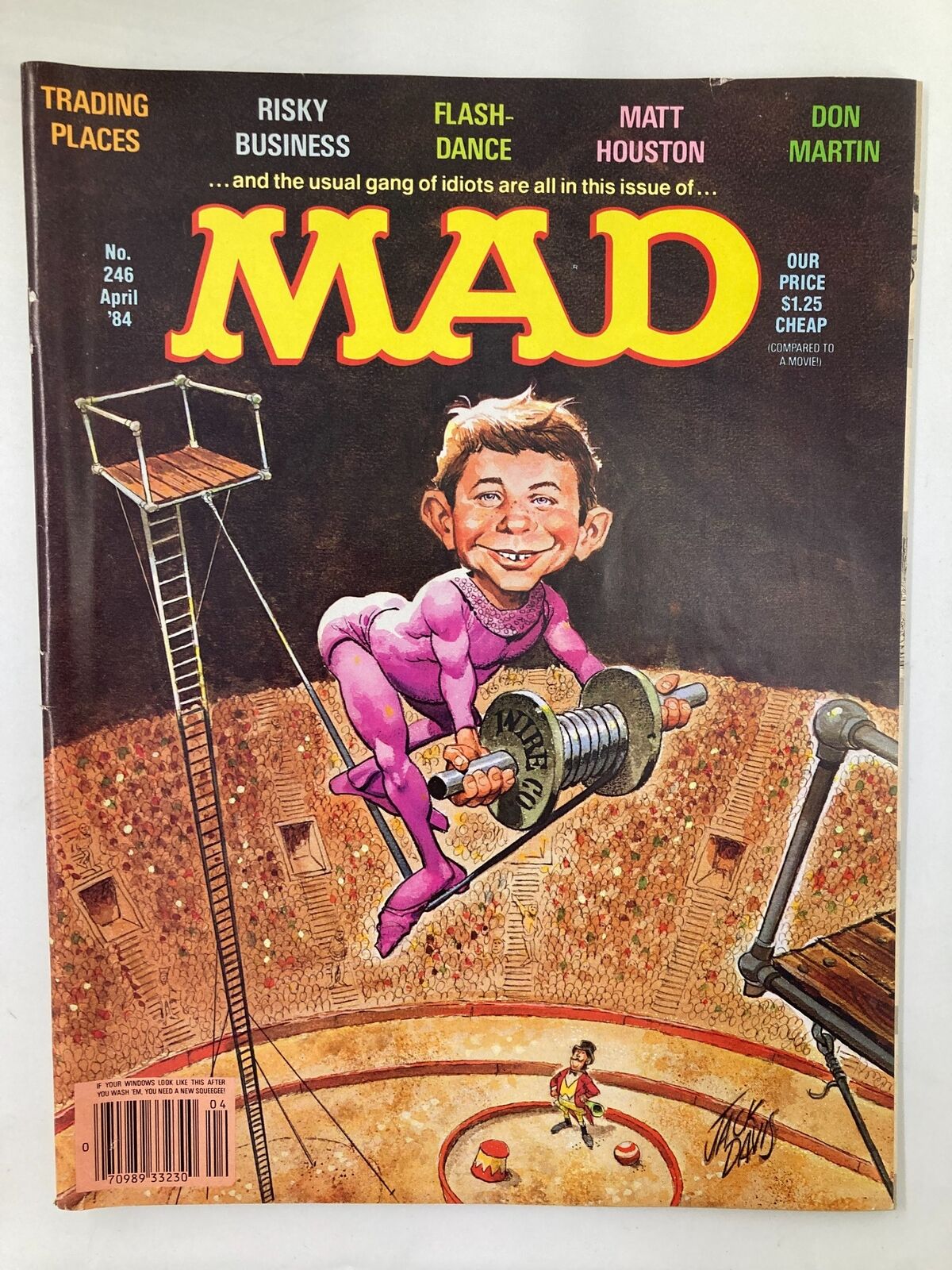 Cover of Mad Magazine April 1984 No. 246 featuring Alfred E. Neuman on a tightrope, showcasing vibrant colors and comedic illustrations, representing 1980s pop culture satire.