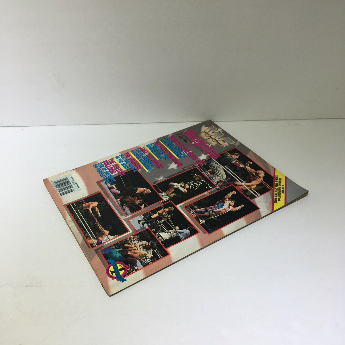 WWF Magazine: Wrestle Mania VII - Ultimate Warrior - June 1991, angled view of the back of the magazine displaying multiple wrestling photos and promotional text about the magazine's content.