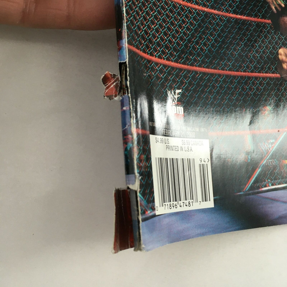Close-up of the wear on the binding of WWF Magazine February 2000, highlighting its vintage character and authenticity.