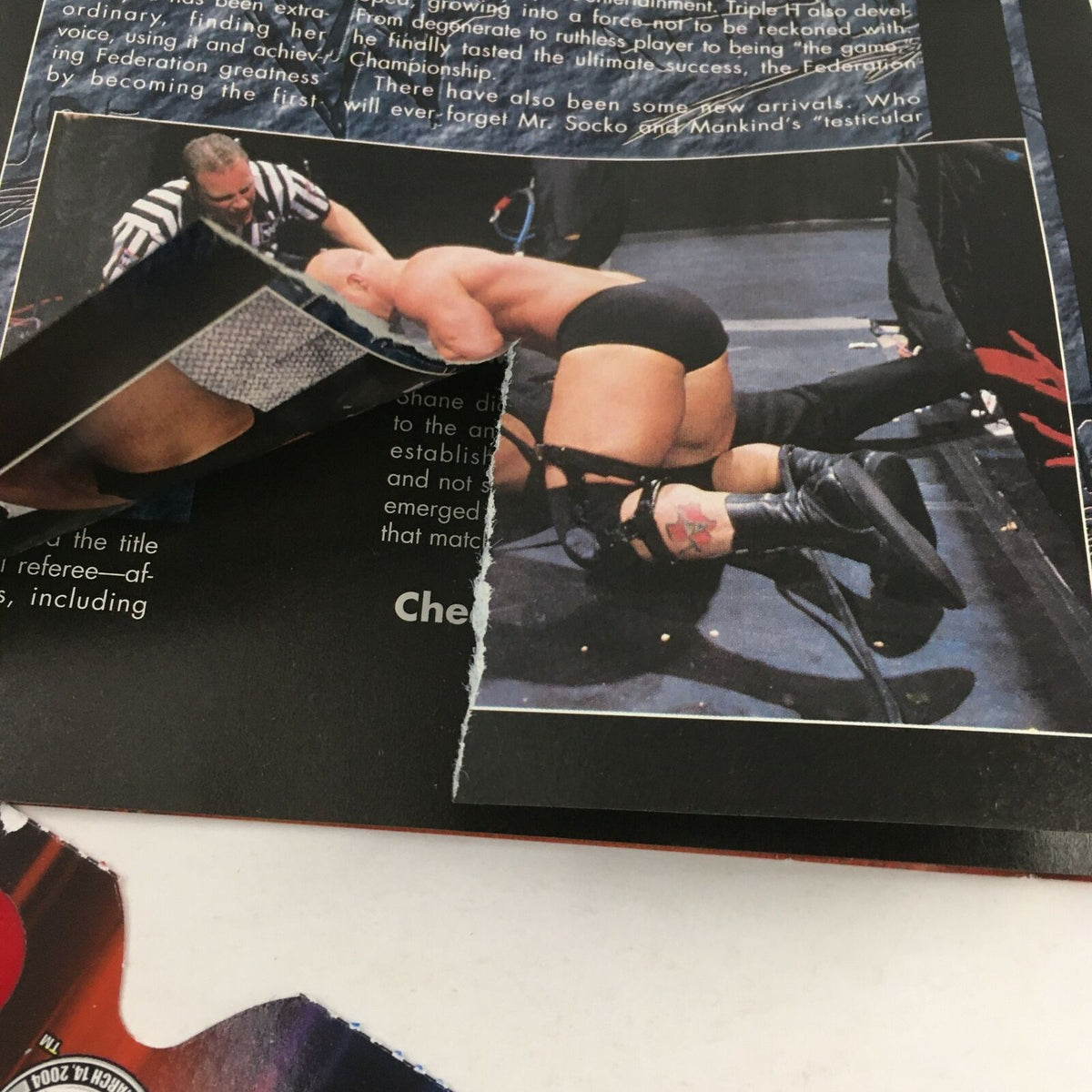 Page from WWF Magazine February 2000 showing wrestling action with a vintage tear, illustrating the magazine's collectible nature.