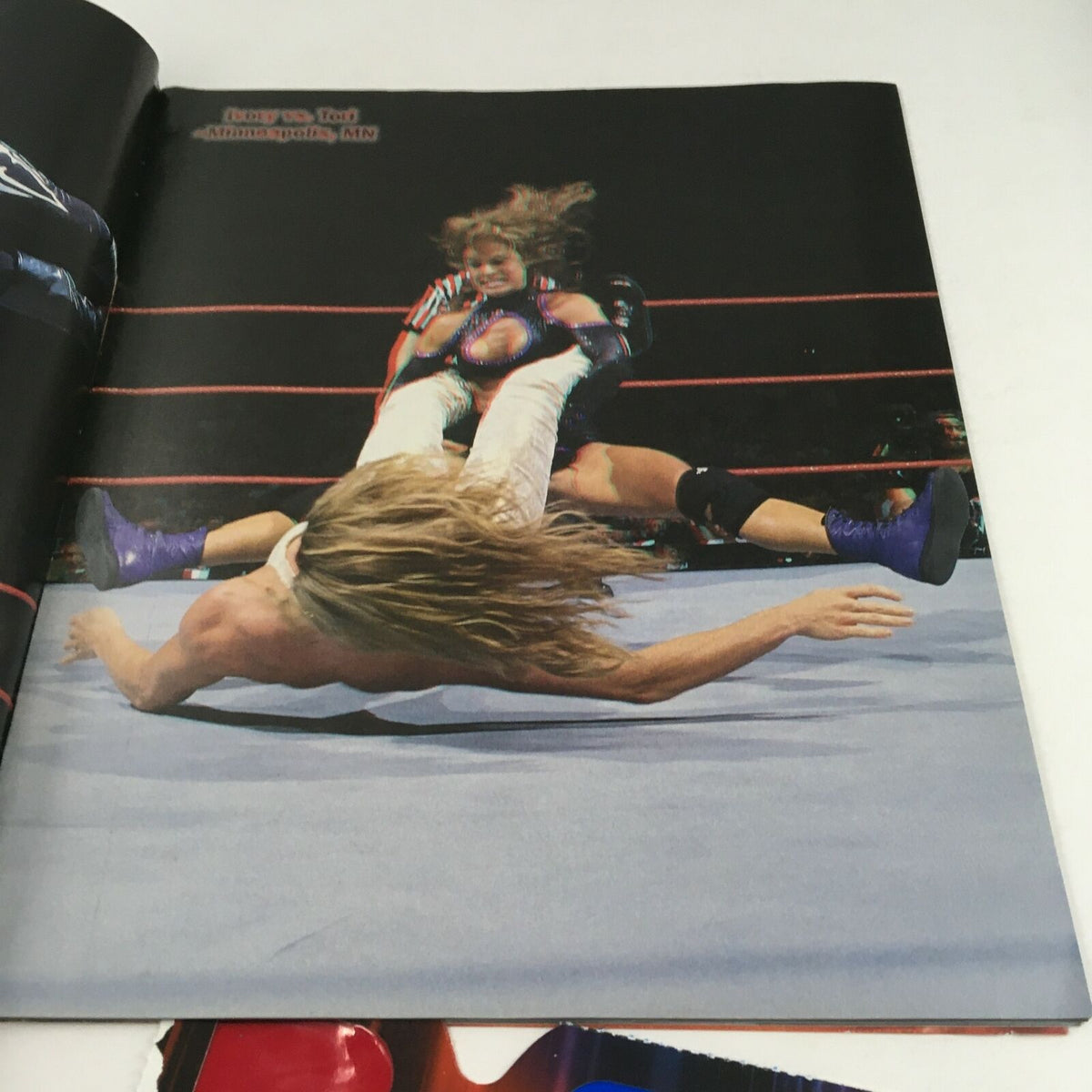 WWF Magazine February 2000 Best of '99 in 3-D, featuring an action shot of a wrestling match where a wrestler performs a move on their opponent in the ring.