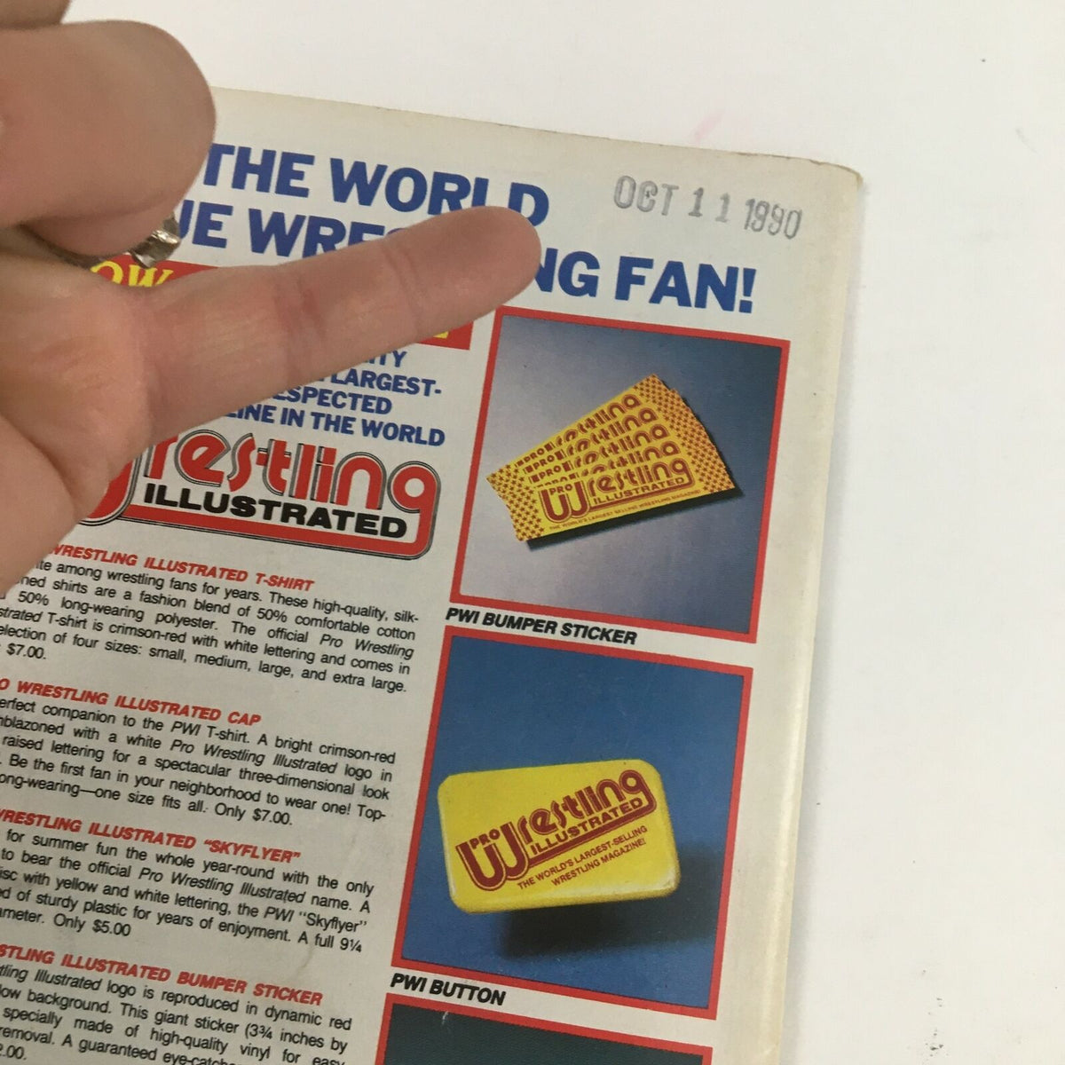 Close-up of the merchandise advertisement on the back cover of The Wrestler Magazine December 1990 featuring a bumper sticker and a button.