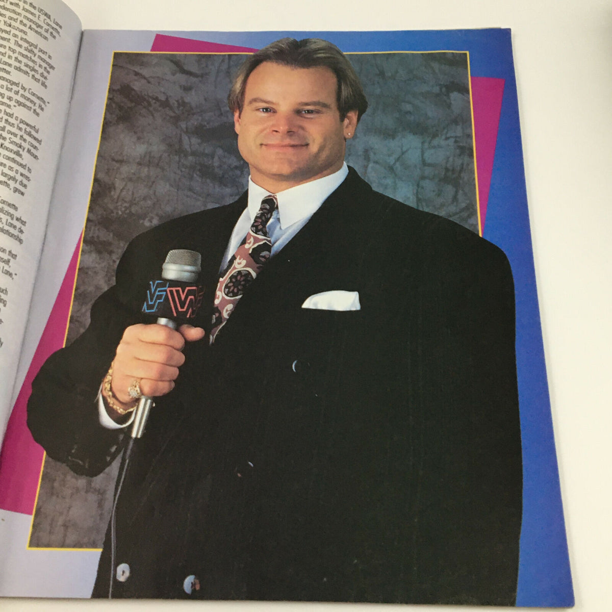 Inside image from WWF Magazine July 1994 of a wrestling personality holding a microphone, dressed in a suit.