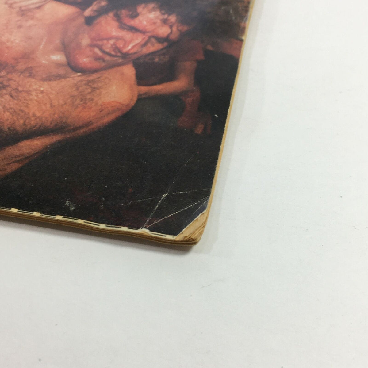 Close-up of the edge of the vintage Inside Wrestling Magazine from May 1980, highlighting minor wear and tear, indicative of its age and collectible nature.