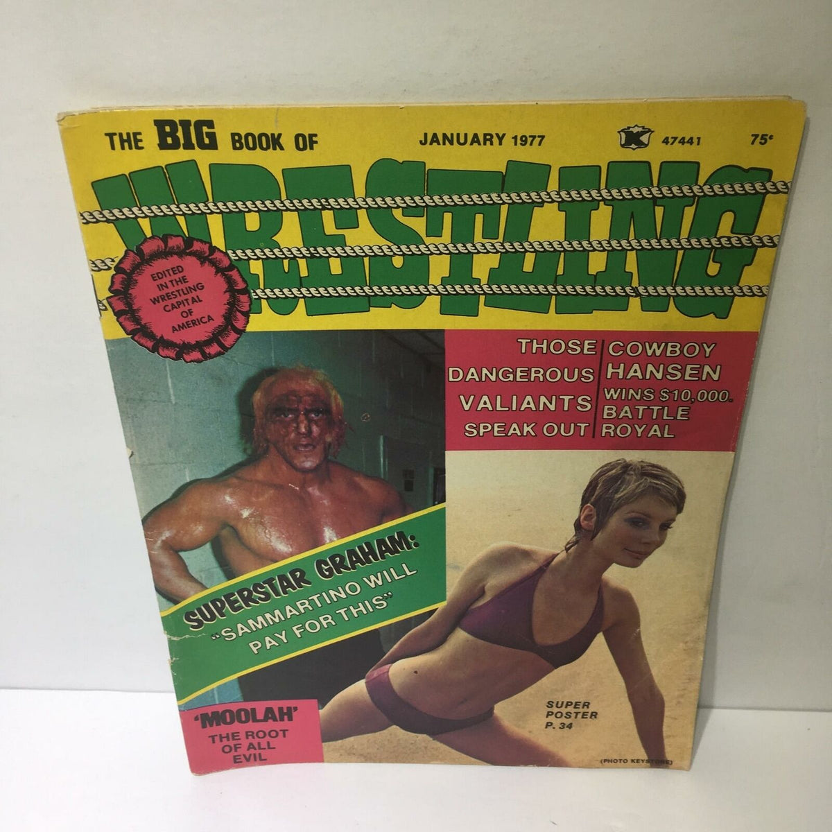 The Big Book of Wrestling January 1977 cover featuring Superstar Graham, showcasing dynamic typography and vintage wrestling themes. The magazine includes highlights of dangerous cowboys, the Valiants, and promotional content for a super poster and battle royal.