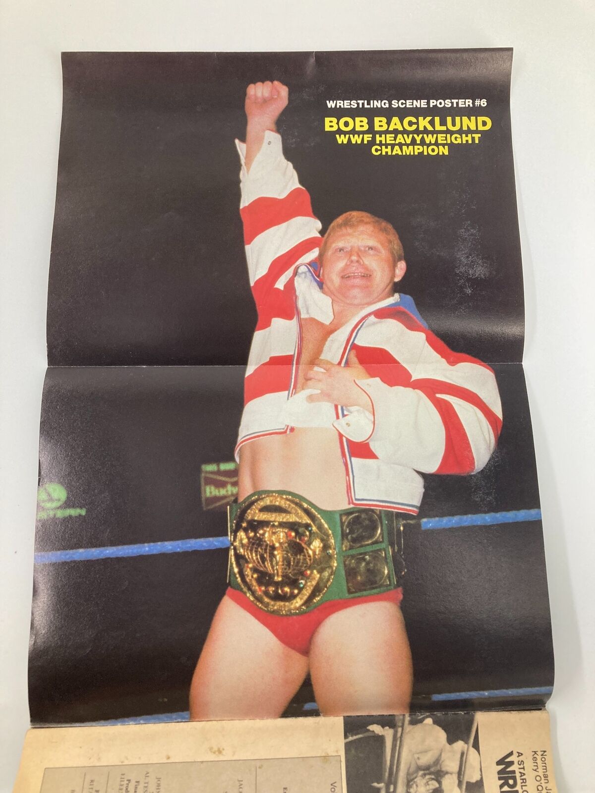 Poster included in VTG Wrestling Scene Magazine May 1983 featuring Bob Backlund, WWF Heavyweight Champion, celebrating with his championship belt.