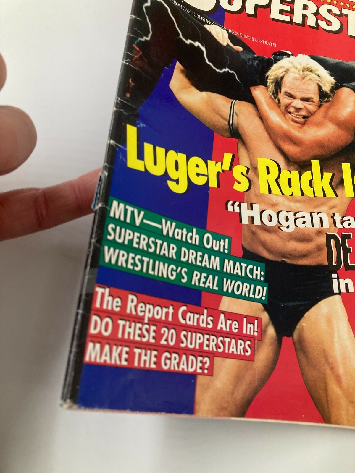 Close-up of the Wrestling Superstars Spring 1996 magazine cover, highlighting the dramatic poses of Lex Luger and Hulk Hogan, along with promotional taglines.