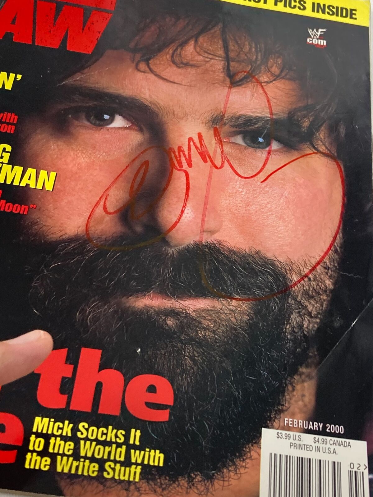 Close-up of the signed cover of WWF Raw Magazine February 2000, highlighting Mick Foley's autograph and dramatic facial expression.