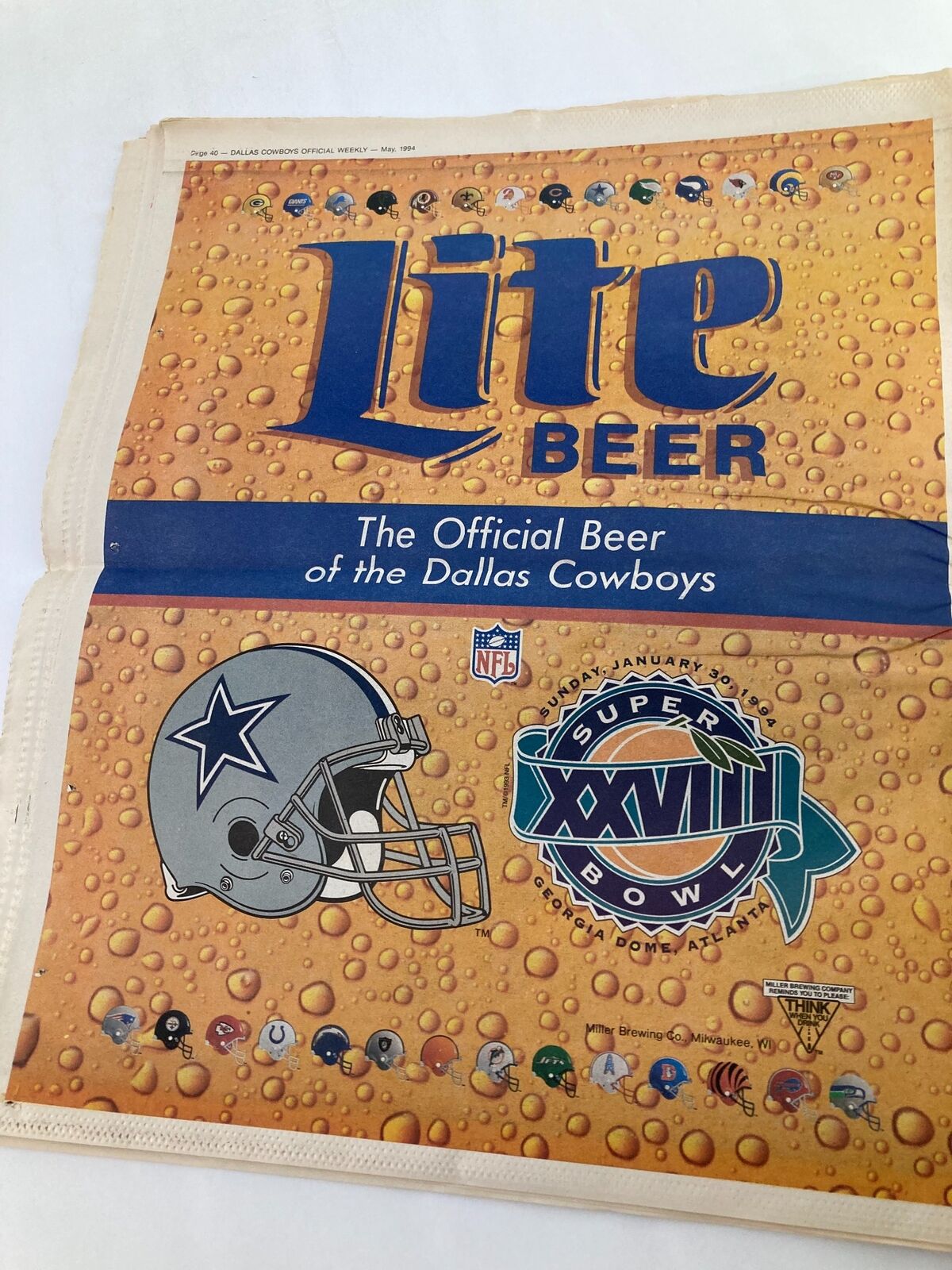 Advertisement for Lite Beer featured in the Dallas Cowboys Weekly Newspaper May 1994 Vol 20 #4 showcasing the official beer of the Dallas Cowboys with a stylized graphic of the team logo and Super Bowl insignia.