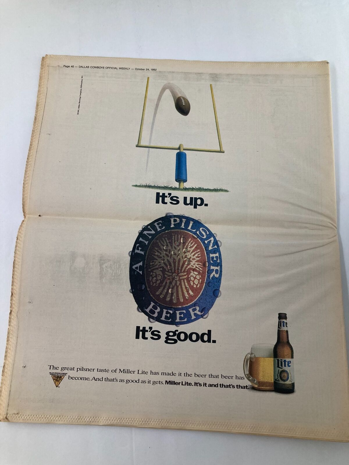 Dallas Cowboys Weekly Newspaper October 24 1992 Vol 18 #19 featuring an advertisement for Miller Lite beer, showcasing a football goalpost and a beer product. The newspaper is in good condition and includes a protective covering.