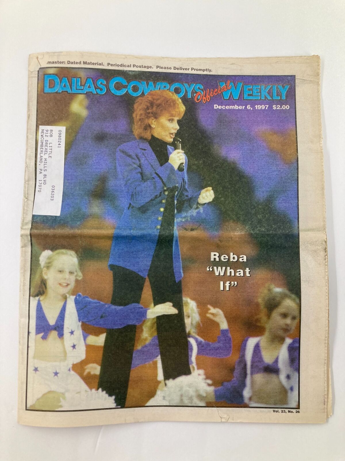 Cover of Dallas Cowboys Weekly newspaper dated December 6, 1997, featuring Reba McEntire on stage, showcasing the headline 'What If?'.
