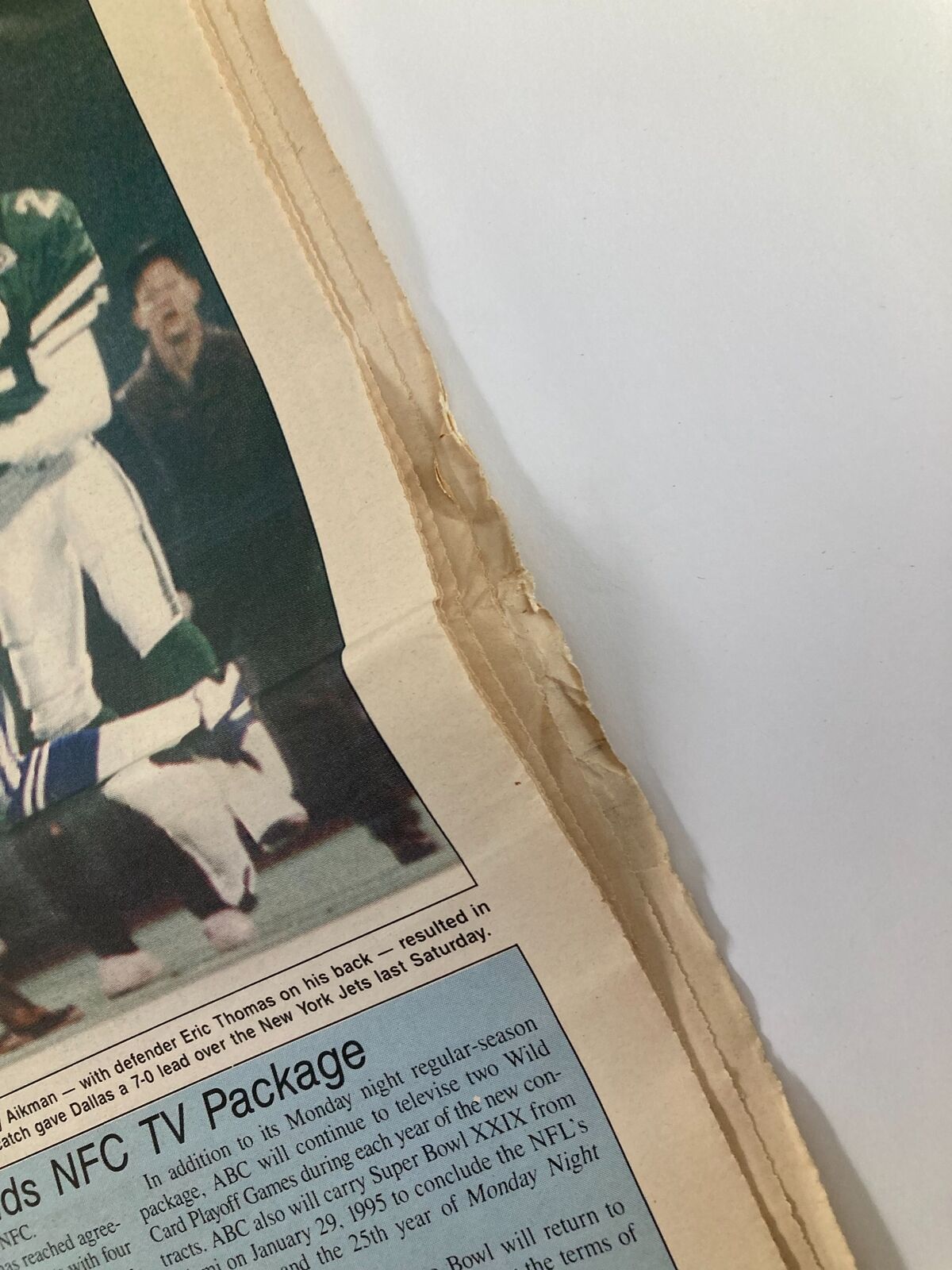 Close-up of Dallas Cowboys Weekly Newspaper December 25 1993 Vol 19 #27 showing minor wear on the edge of the page.