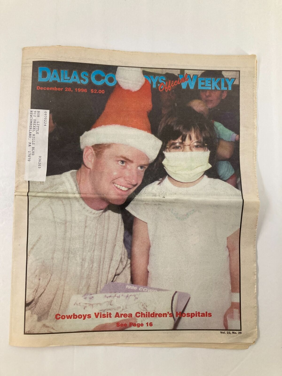 Dallas Cowboys Weekly Newspaper December 28 1996 Vol 22 #29 featuring a holiday-themed cover with a player in a Santa hat and a child in a mask at a hospital event.