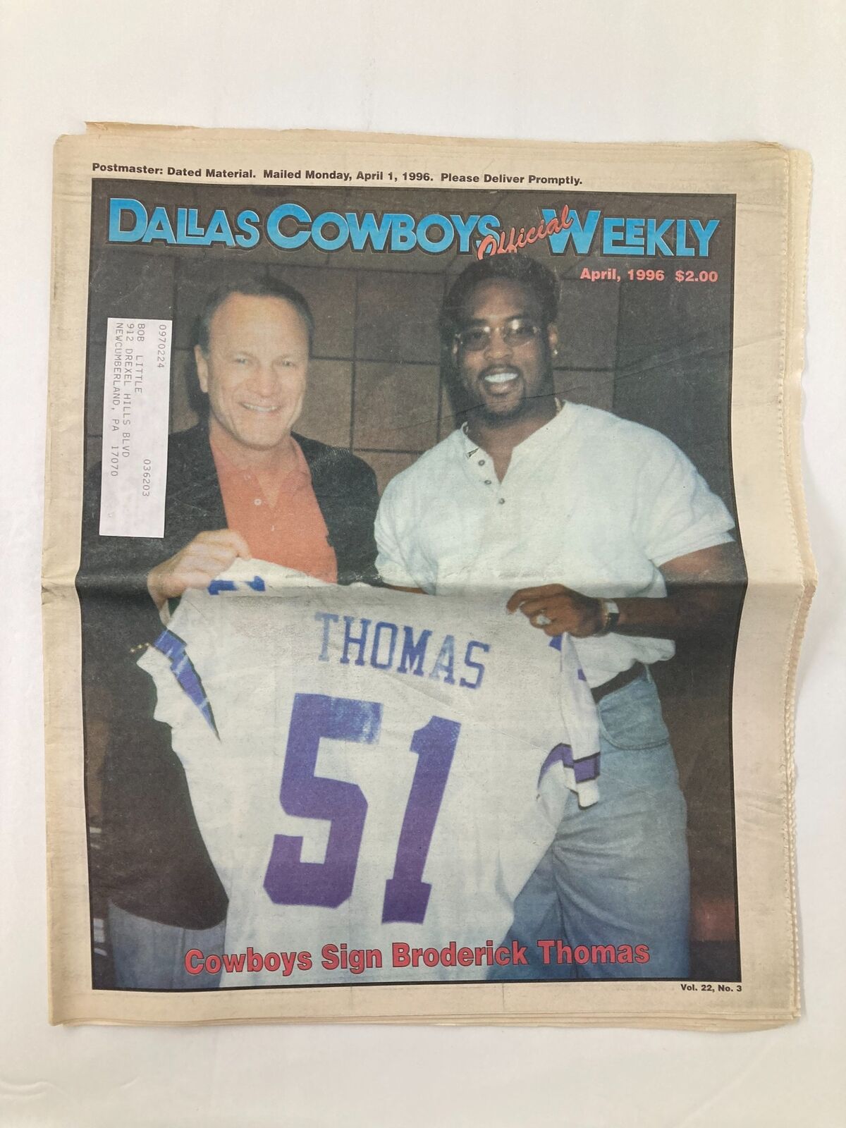 Dallas Cowboys Weekly Newspaper April 1996 Vol 22 #3 featuring Broderick Thomas on the cover, showcasing the Cowboys' signing announcement with a photo of Thomas holding his signed jersey, in good condition and protected.