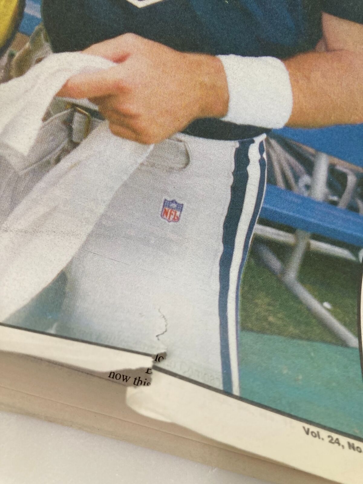 Close-up image highlighting the NFL logo on the pants worn by a Dallas Cowboys player in the 'Dallas Cowboys Weekly' newspaper from August 22, 1998, Vol 24 #10.