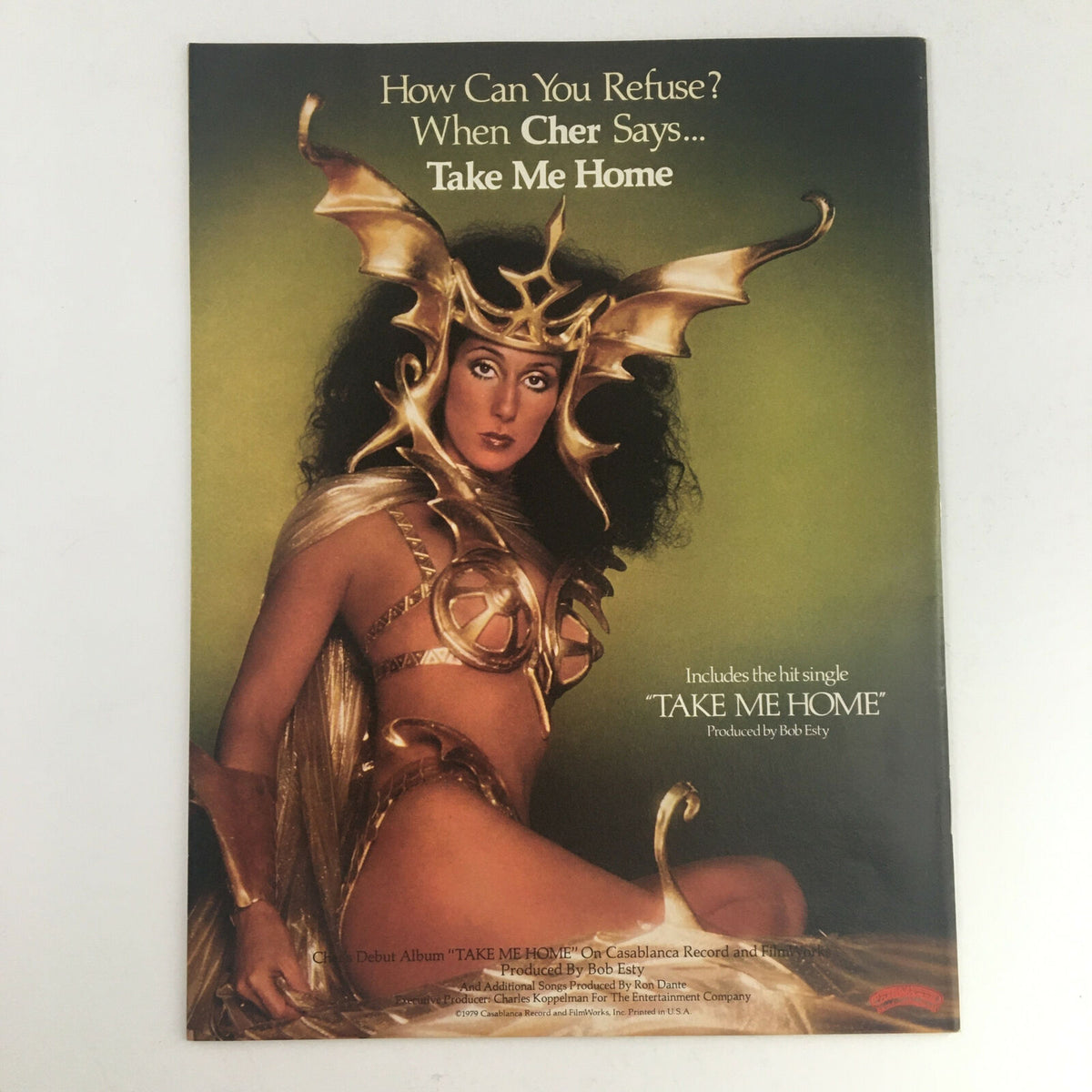 Promotional image for Cher's album 'Take Me Home' featured in Circus Magazine March 13 1979, showcasing Cher in an elaborate costume, reflecting the glamour of the disco era.