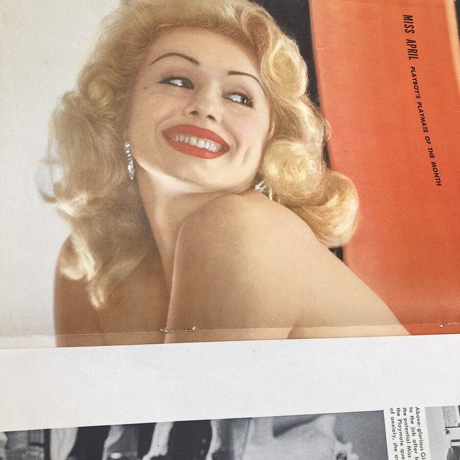 Playboy Magazine April 1956 featuring Playmate Rusty Fisher smiling with a charming expression, showcasing vintage beauty and style.