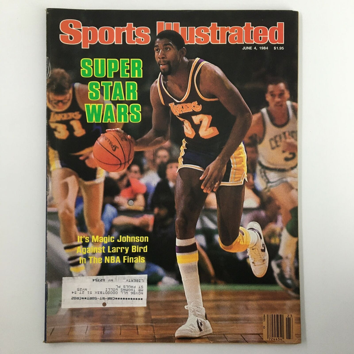 Cover of Sports Illustrated magazine from June 4, 1984, featuring basketball legends Magic Johnson and Larry Bird, highlighting their rivalry in the NBA Finals. The cover is titled 'SUPER STAR WARS' and showcases Magic Johnson in action on the court.