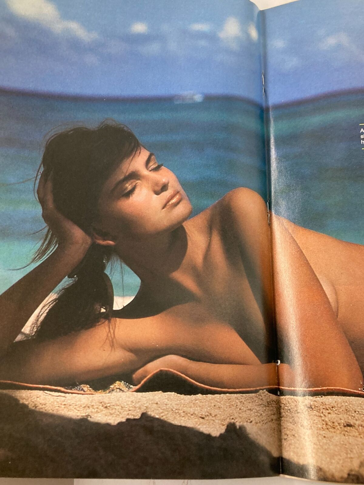 Model lounging on the beach in a sensual pose from VTG Sports Illustrated Magazine February 14 1983, showcasing the relaxed vibe of summer in the early 1980s.