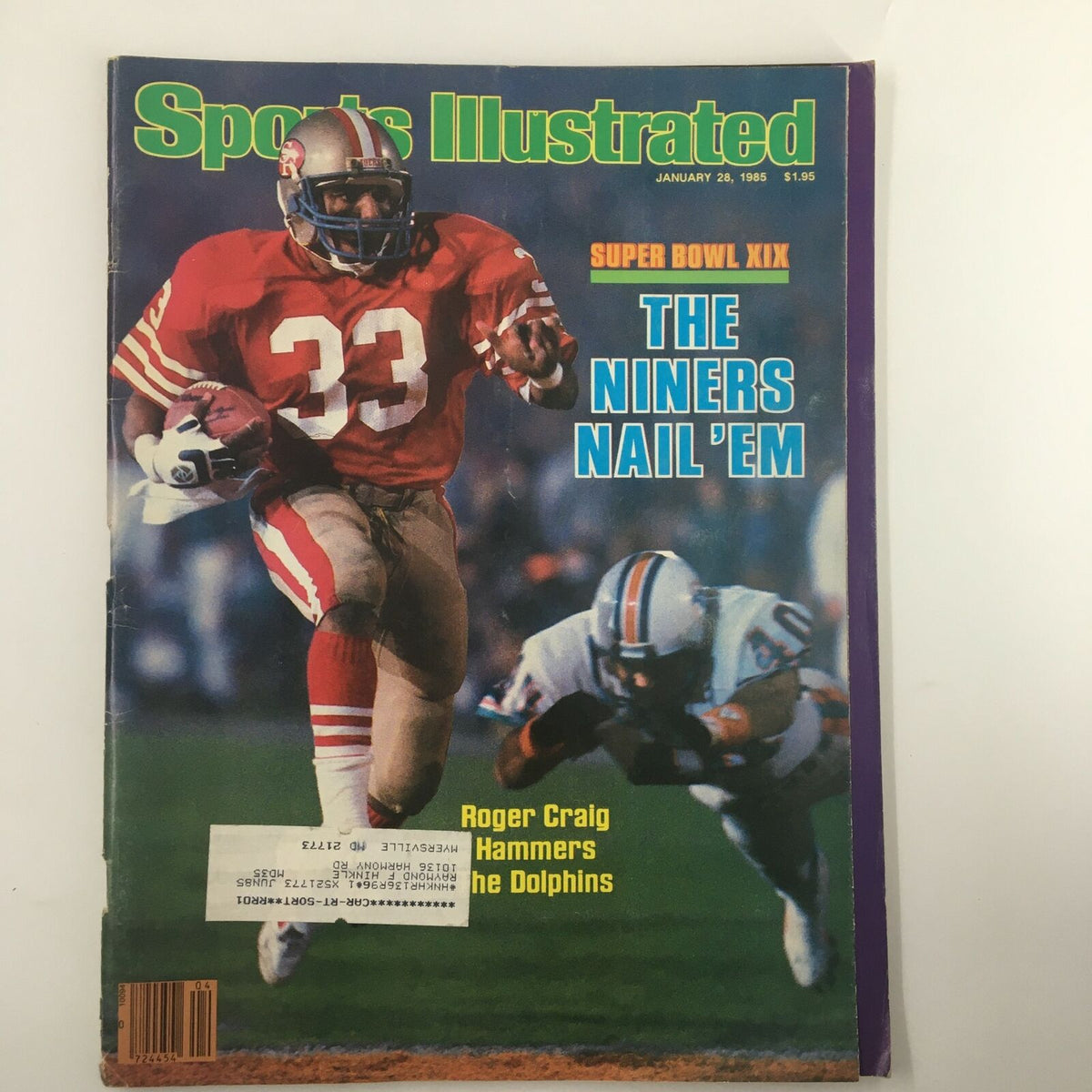 Sports Illustrated Magazine from January 28, 1985, featuring Roger Craig in action on the cover as he hammers the Dolphins. This iconic issue highlights Super Bowl XIX and captures a pivotal moment in NFL history.