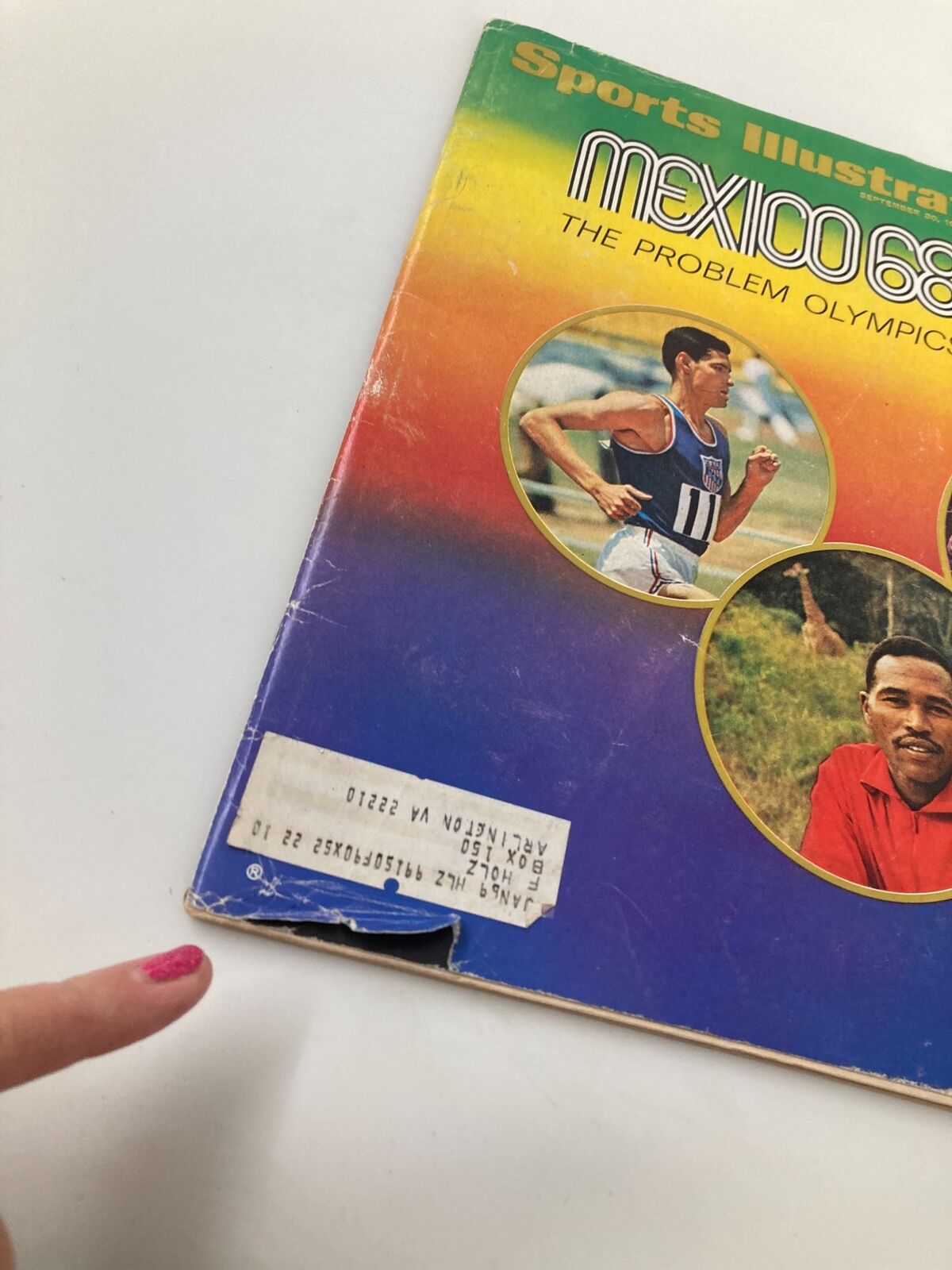 Close-up view of the Vintage Sports Illustrated Magazine 'Mexico 68: The Problem Olympics' from September 30, 1968, highlighting condition details and a visible label.