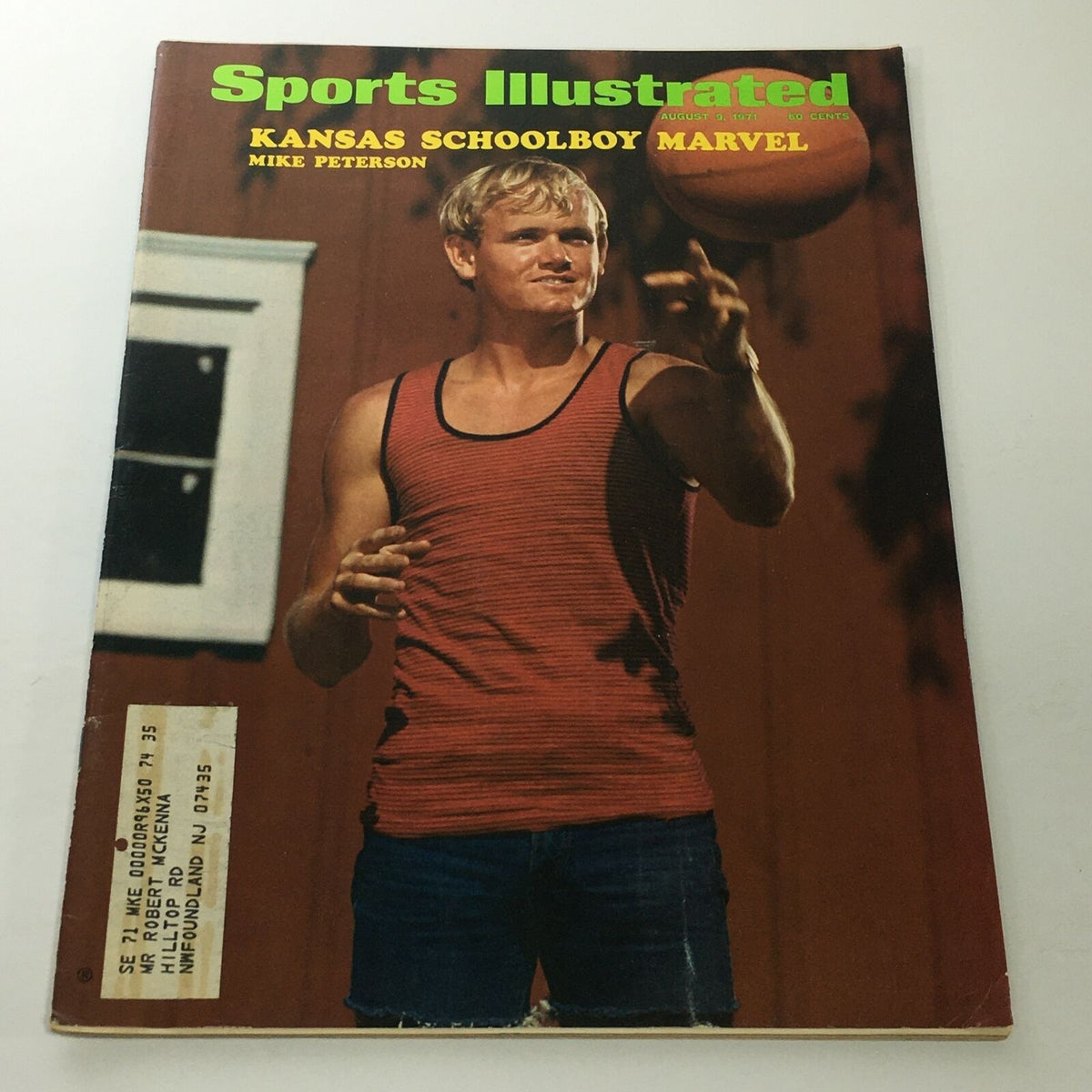 Cover of Sports Illustrated dated August 9, 1971 featuring Kansas schoolboy marvel Mike Peterson, showcasing him in a casual pose with a red tank top.