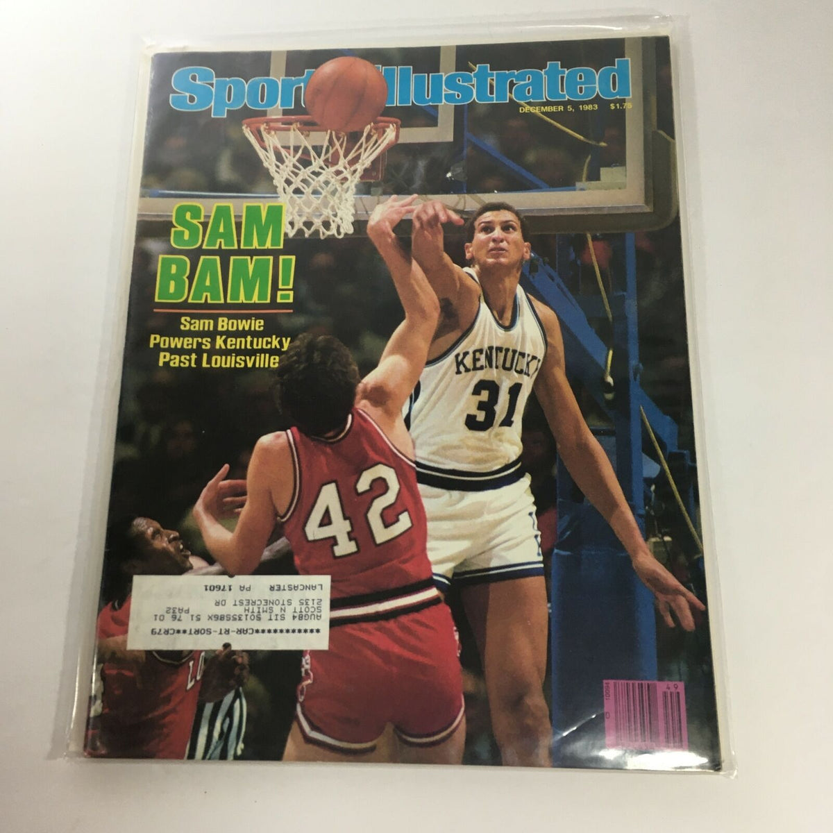 Sports Illustrated magazine cover from December 5, 1983, featuring Sam Bowie of Kentucky prominently dunking the basketball while an opposing player watches. The cover highlights Bowie with the tagline 'Sam Bam!' and references the game against Louisville.