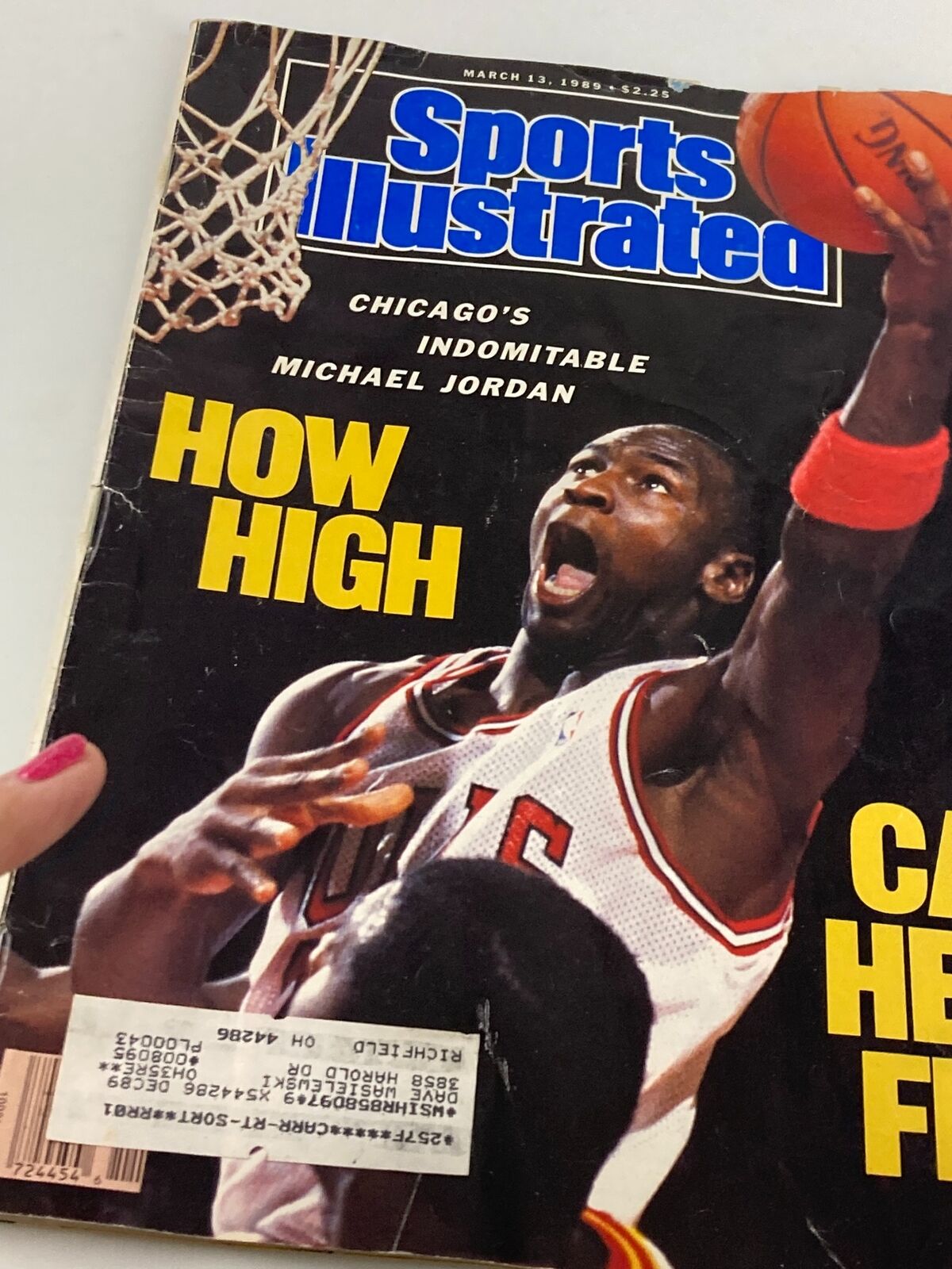 Close-up of Sports Illustrated Magazine March 13 1989 cover displaying Michael Jordan and the title 'How High Can He Fly?' highlighting his athletic prowess.