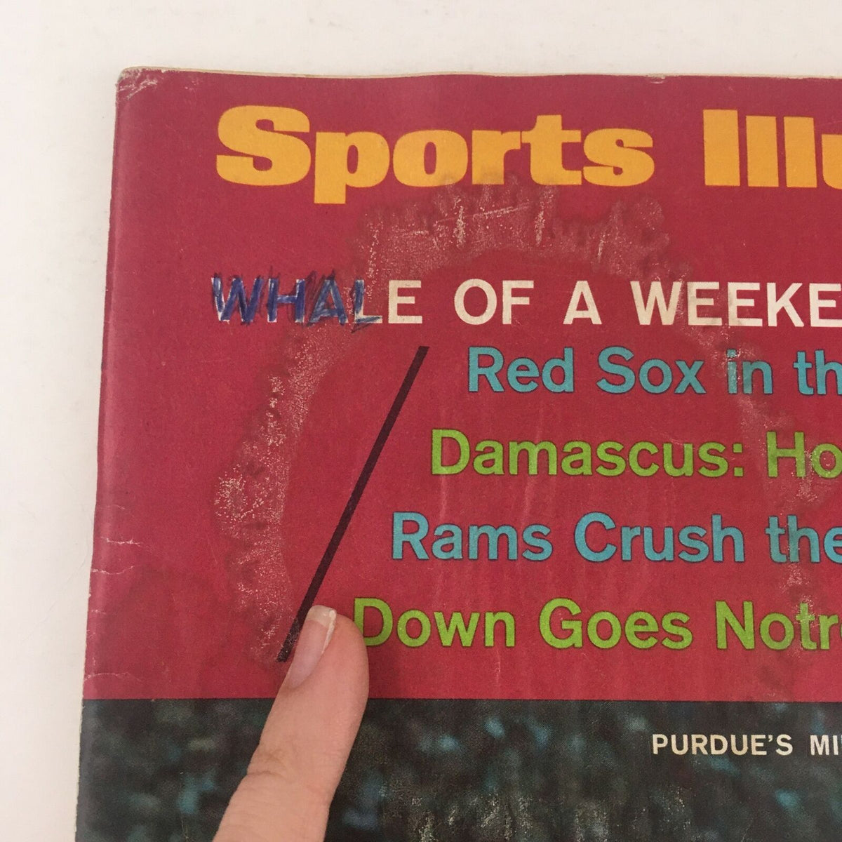 Detailed view of the title section on the cover of Sports Illustrated Magazine from October 9, 1967, featuring the words 'WHALe OF A WEEKEND' among sports headlines.