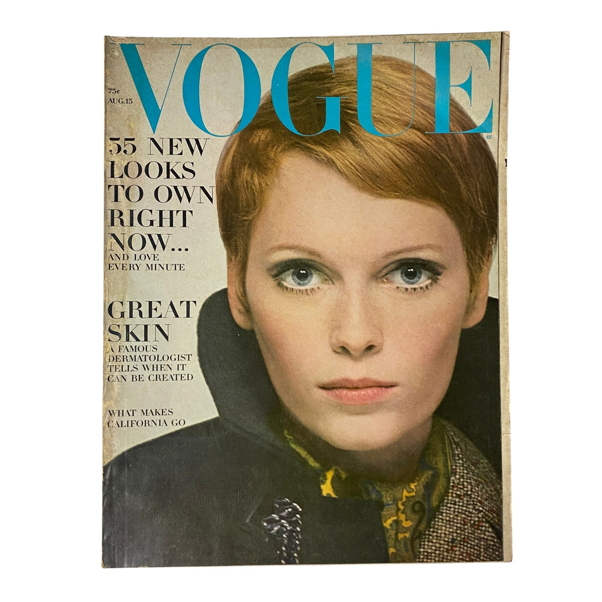 Vogue Magazine August 15, 1967 cover featuring a model with striking blue eyes and bold makeup, highlighting fashion trends and beauty tips.