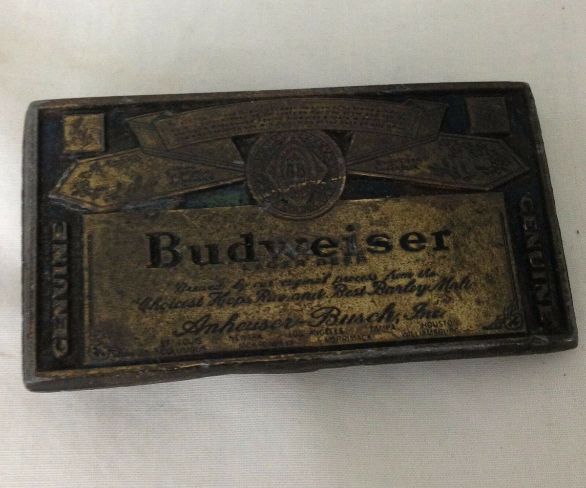Vintage 1974 Budweiser Anheuser-Busch beer belt buckle featuring detailed design with the brand name in a classic style.
