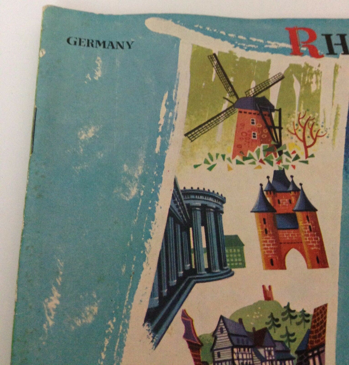 Close-up view of a detailed illustration on the cover of Vintage 1950s GUIDE BOOKLET Rhineland Germany, featuring scenic architecture.