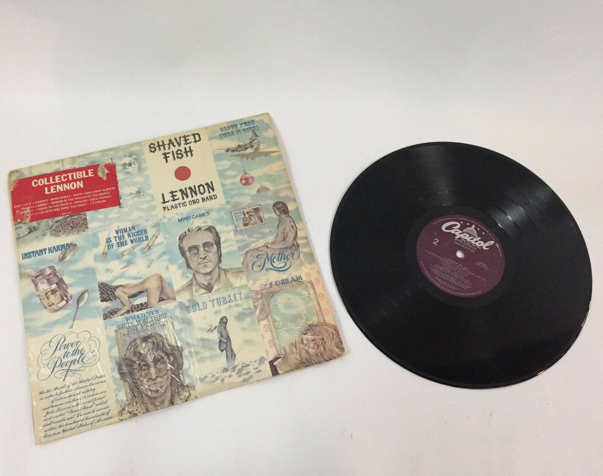 JOHN LENNON--SHAVED FISH--APPLE--SW-3421 vinyl record displayed alongside its album cover featuring artistic imagery and song titles.