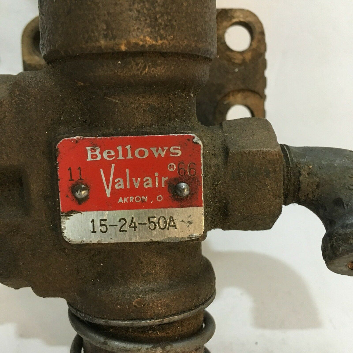 Close-up of the NEW BELLOWS VALVAIR MANUAL VALVE 15-24-50A branding on the valve body, indicating the manufacturer and model details.